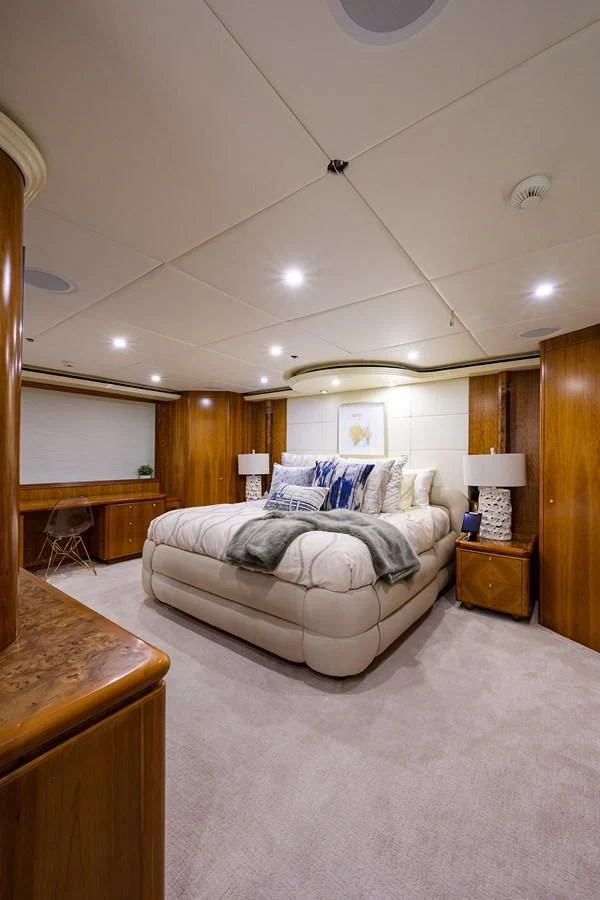 a bedroom with a bed and a desk aboard CABERNET Yacht for Sale