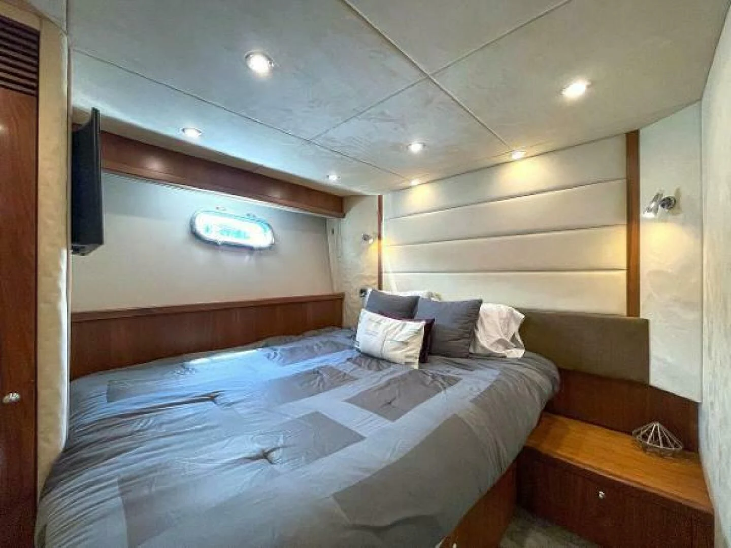 a bedroom with a bed and a desk aboard TWINS Yacht for Sale