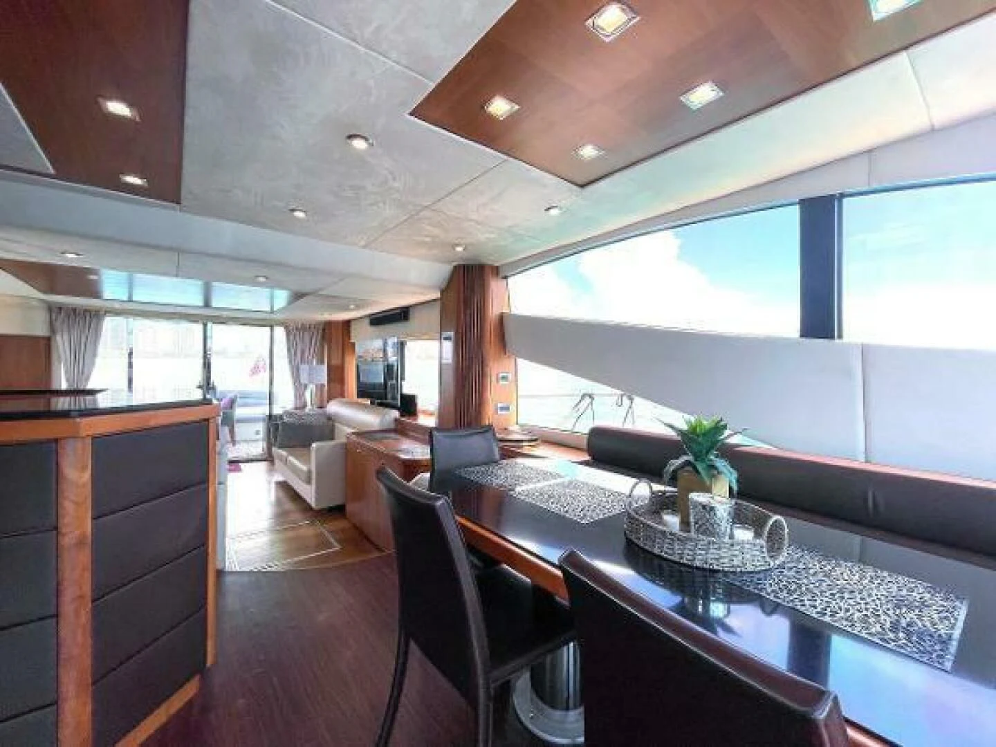 a room with a table chairs and a large window aboard TWINS Yacht for Sale