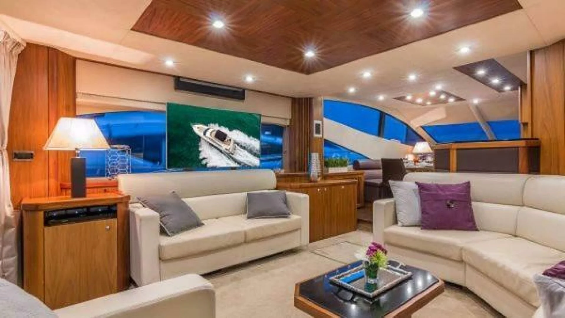 a living room with a large screen aboard TWINS Yacht for Sale