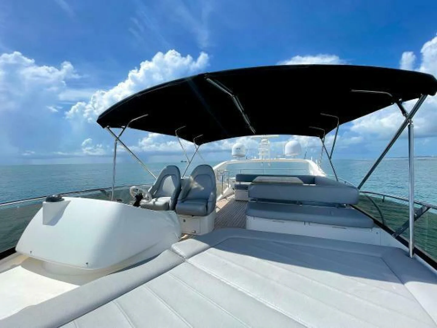 a boat with a large black umbrella aboard TWINS Yacht for Sale