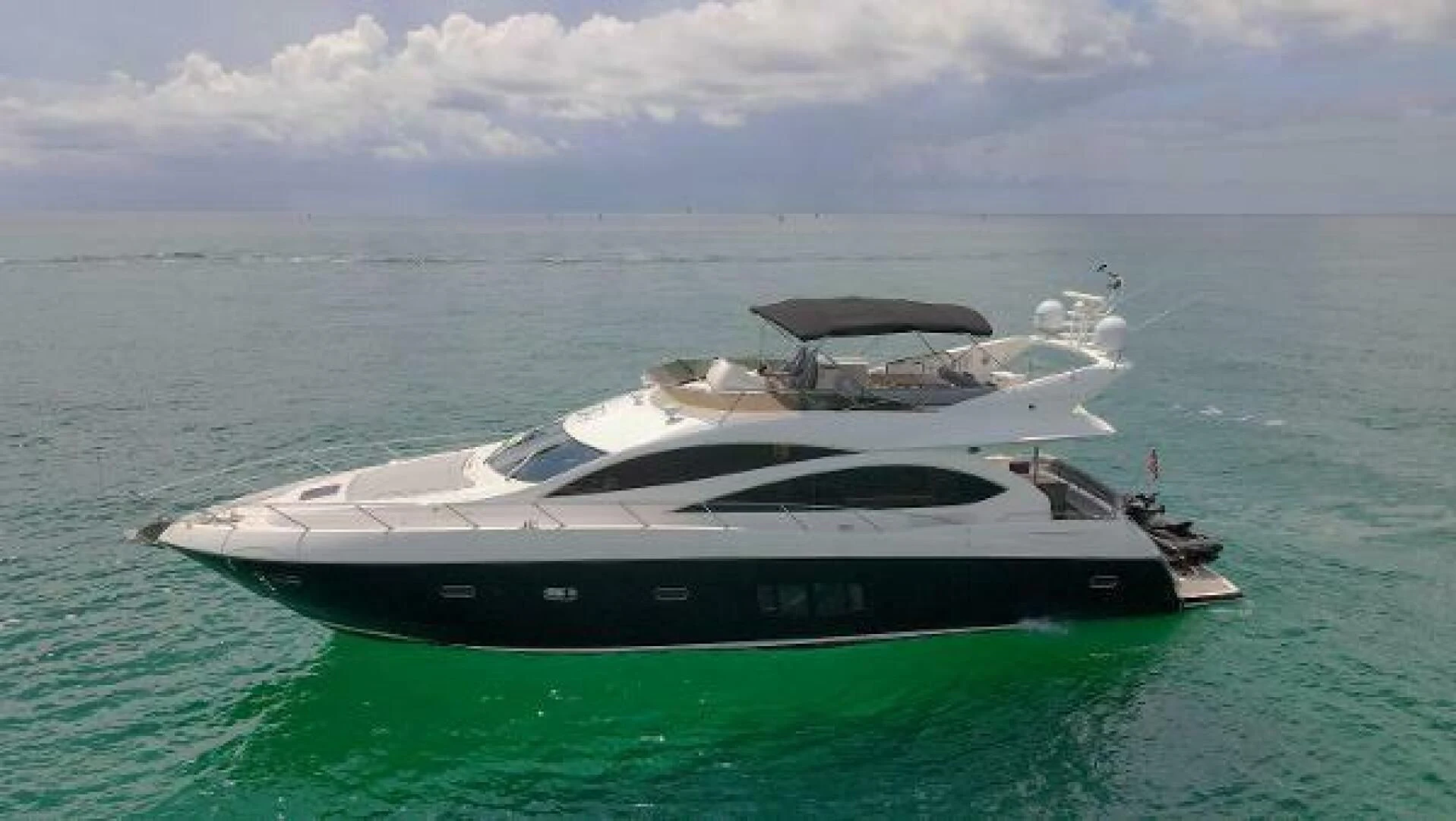 a white yacht in the ocean aboard TWINS Yacht for Sale