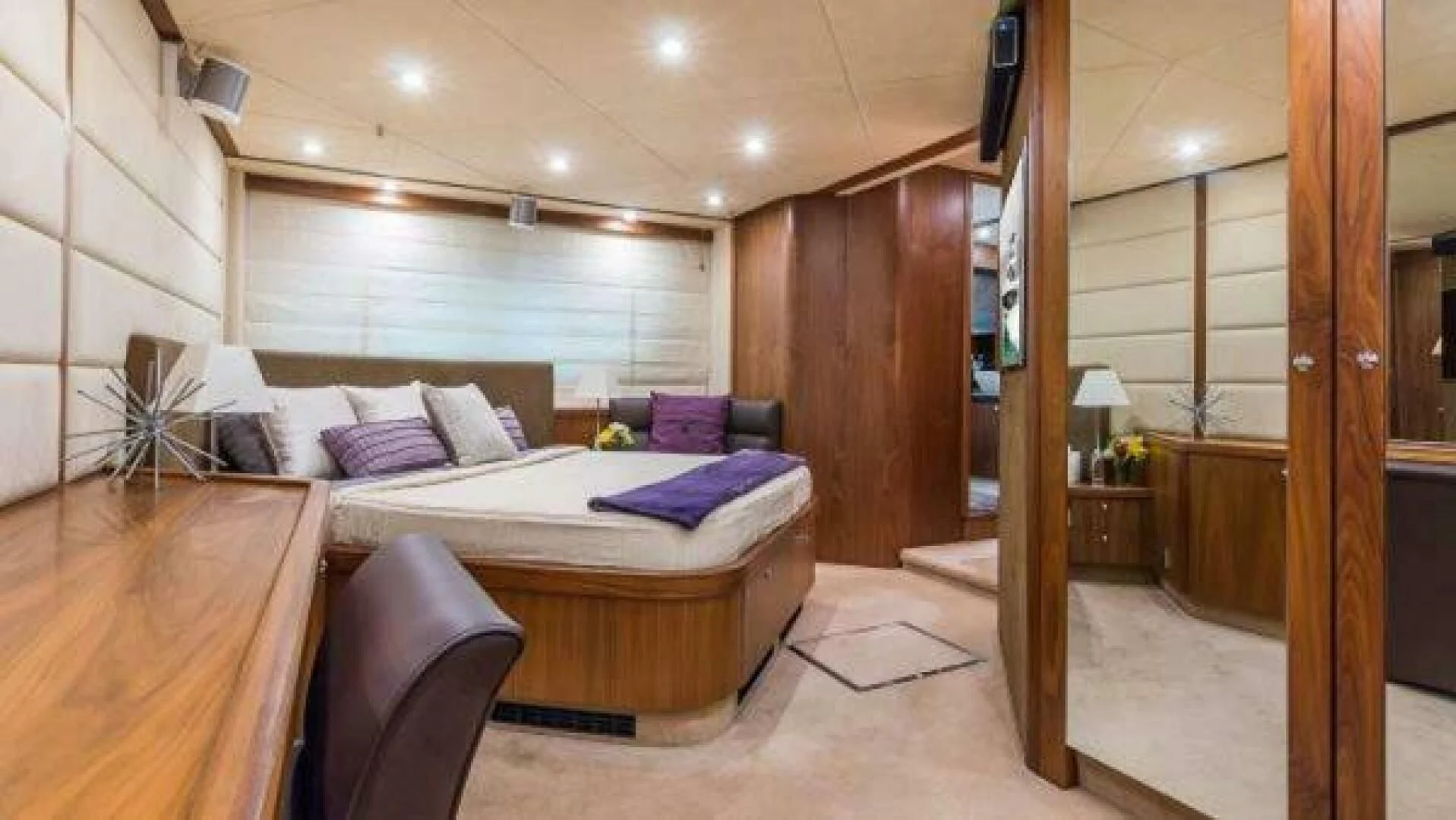 a bedroom with a bed and a desk aboard TWINS Yacht for Sale