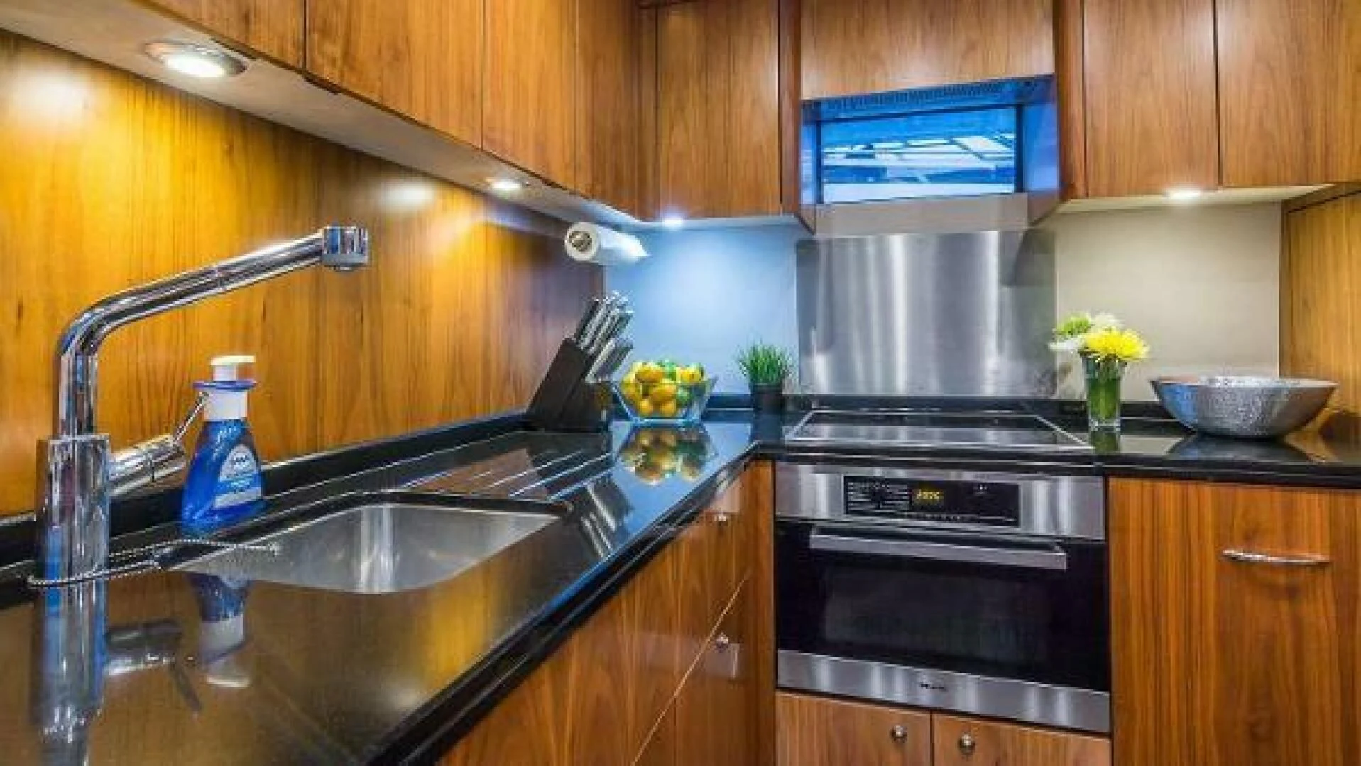 a kitchen with a stainless steel stove and a stainless steel sink aboard TWINS Yacht for Sale