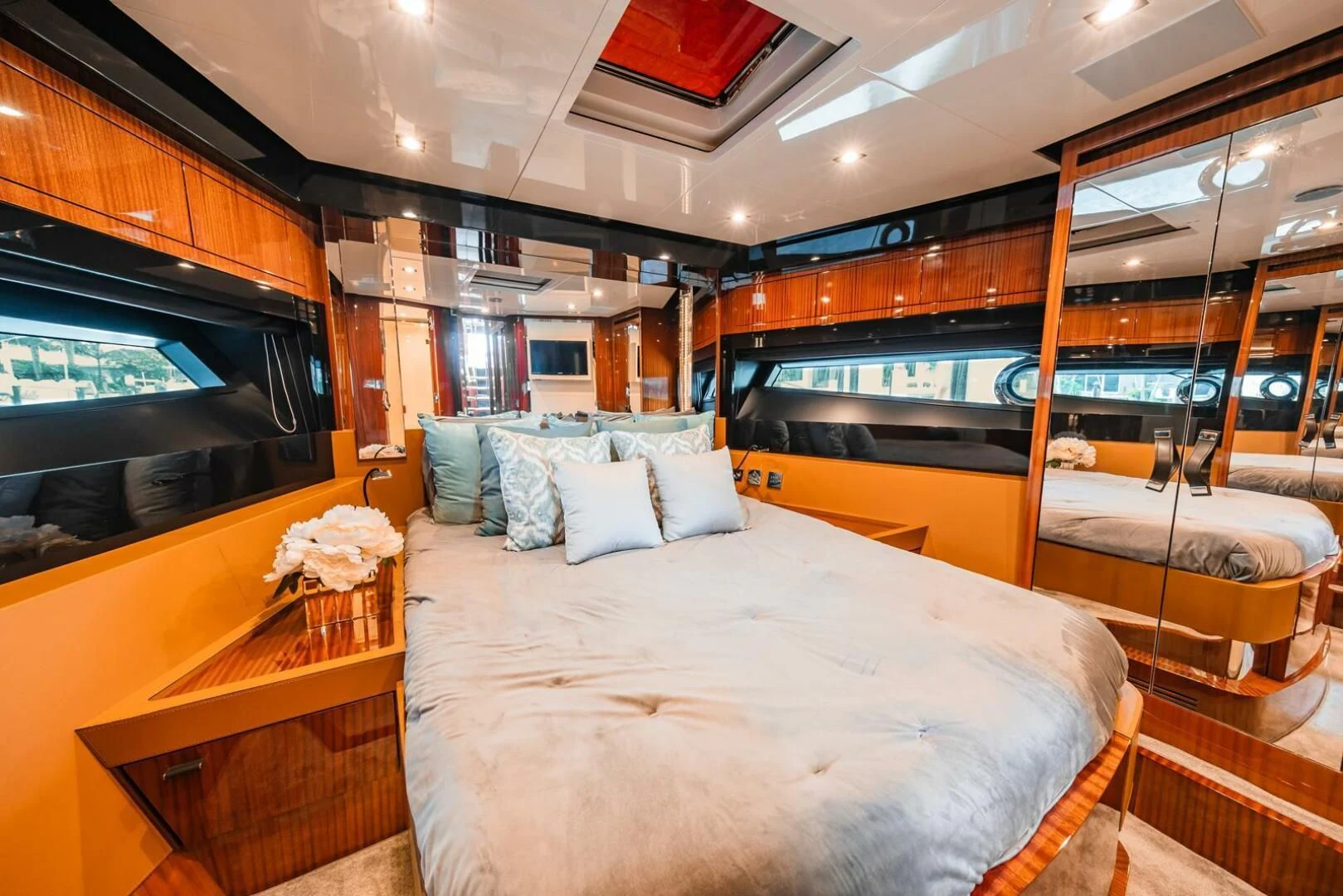 a bedroom with a bed and a tv aboard REGENCY Yacht for Sale