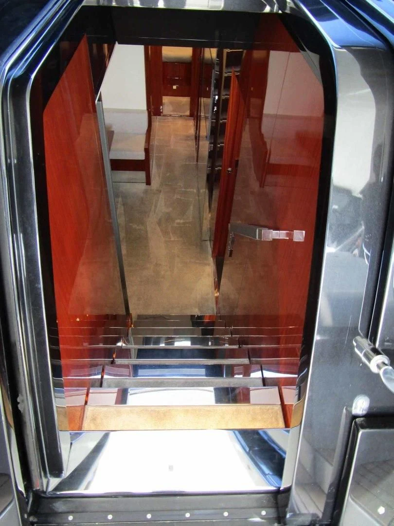 a hallway with red doors aboard REGENCY Yacht for Sale