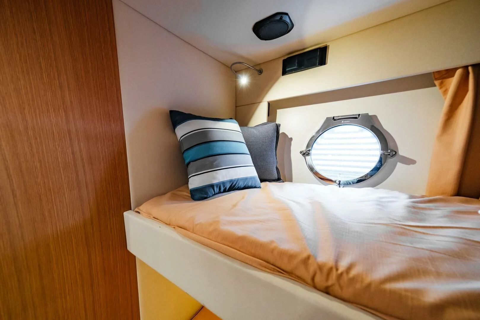 a bed with a mirror on the wall aboard REGENCY Yacht for Sale