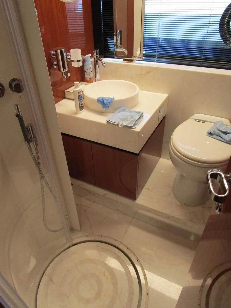 a bathroom with a sink toilet and a bathtub aboard REGENCY Yacht for Sale