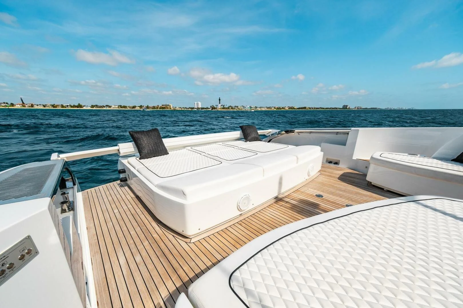 a deck with a view of the water and a city in the background aboard REGENCY Yacht for Sale
