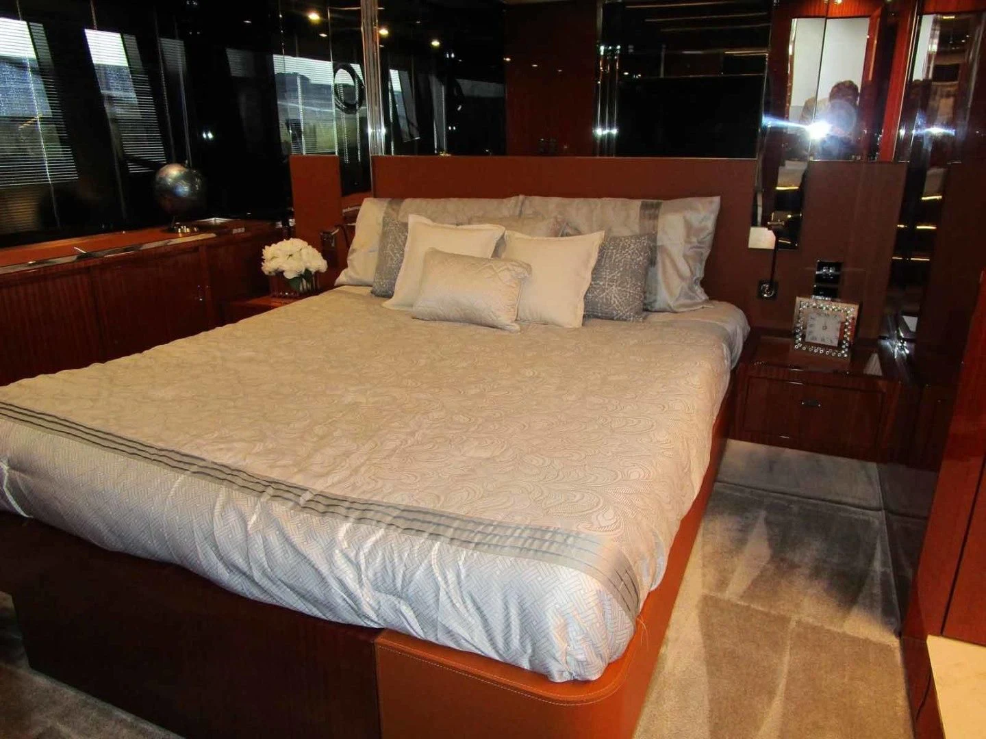 a bed with a white comforter aboard REGENCY Yacht for Sale