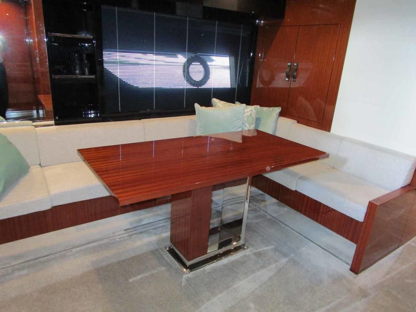 a table and bench in a room aboard REGENCY Yacht for Sale
