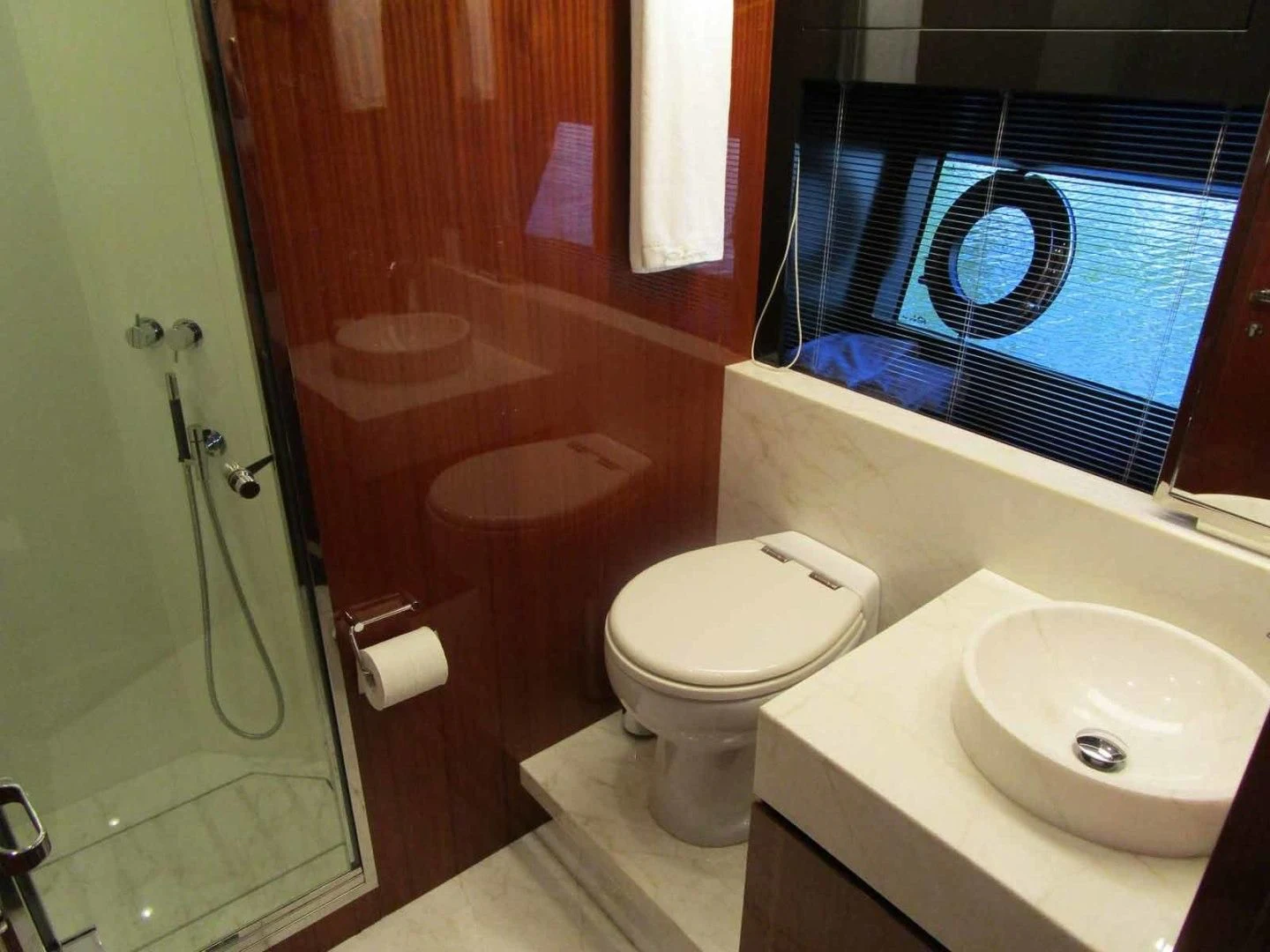 a bathroom with a toilet and sink aboard REGENCY Yacht for Sale