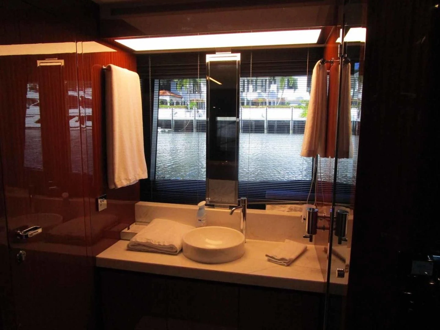 a bathroom with a sink and a large window aboard REGENCY Yacht for Sale