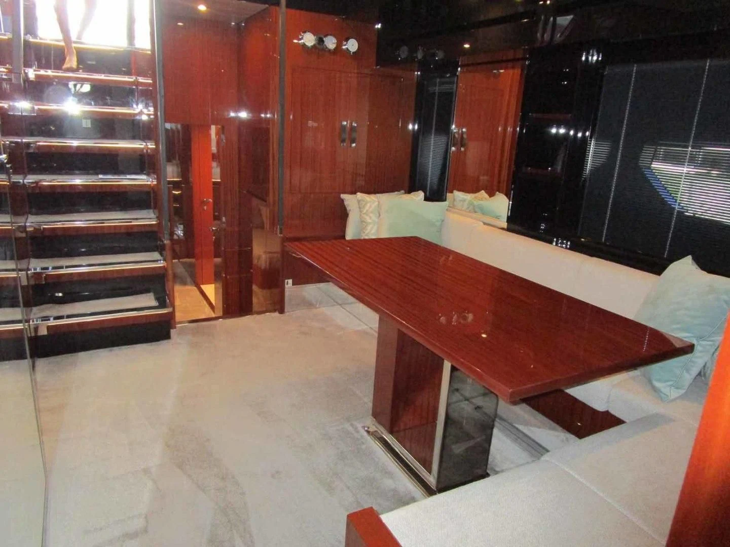a room with a table and chairs aboard REGENCY Yacht for Sale