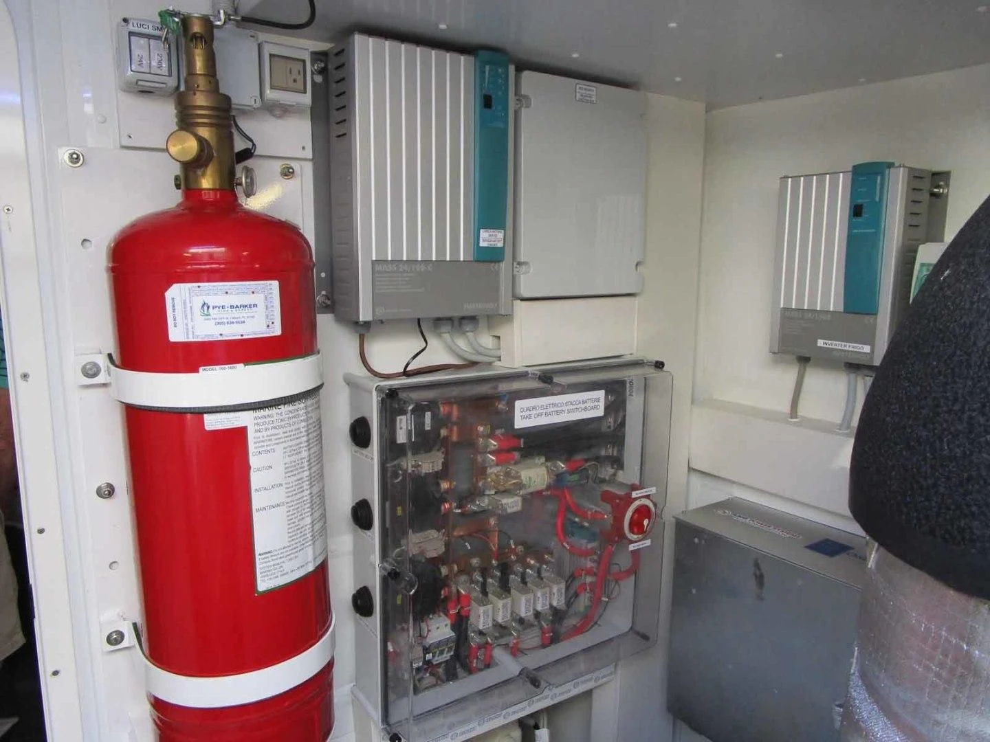 a red and white fire extinguisher in a room aboard REGENCY Yacht for Sale