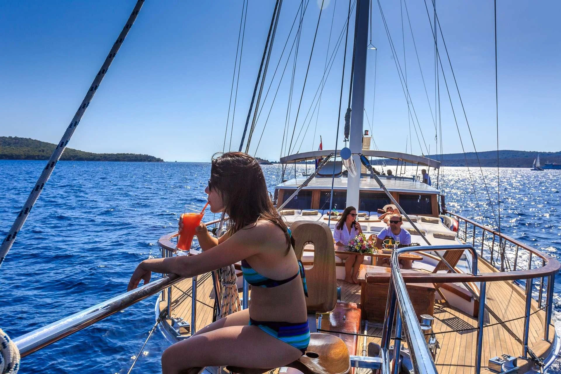 a woman in a bikini on a boat aboard ALLURE E Yacht for Sale