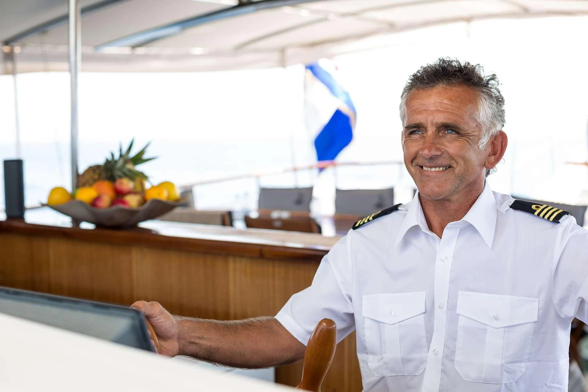 a man in a white shirt aboard ALLURE E Yacht for Sale