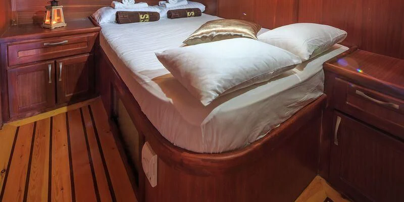 a bed with white sheets aboard ALLURE E Yacht for Sale