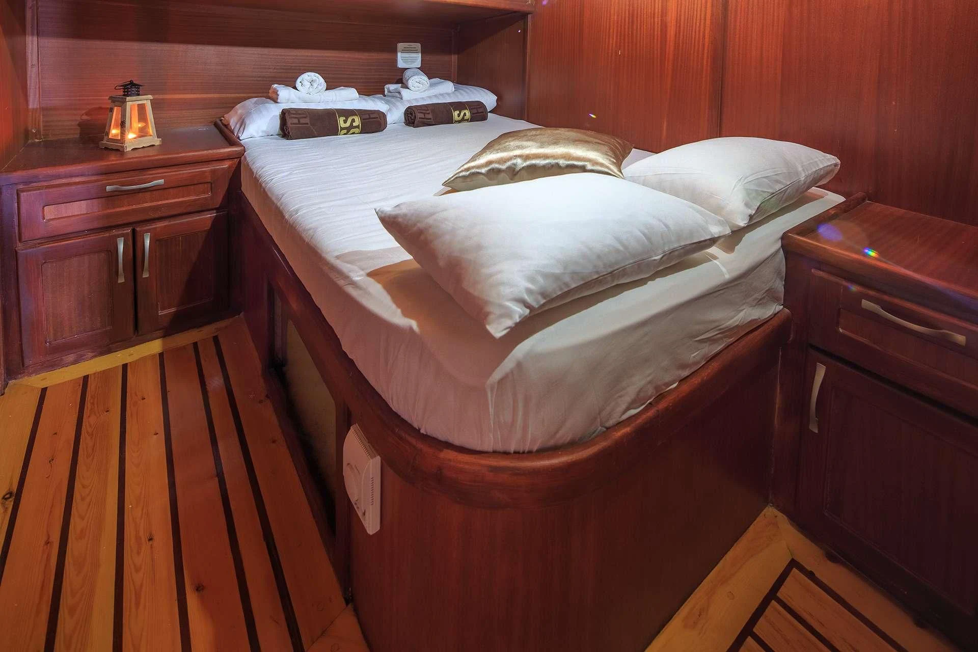 a bed with white sheets aboard ALLURE E Yacht for Sale