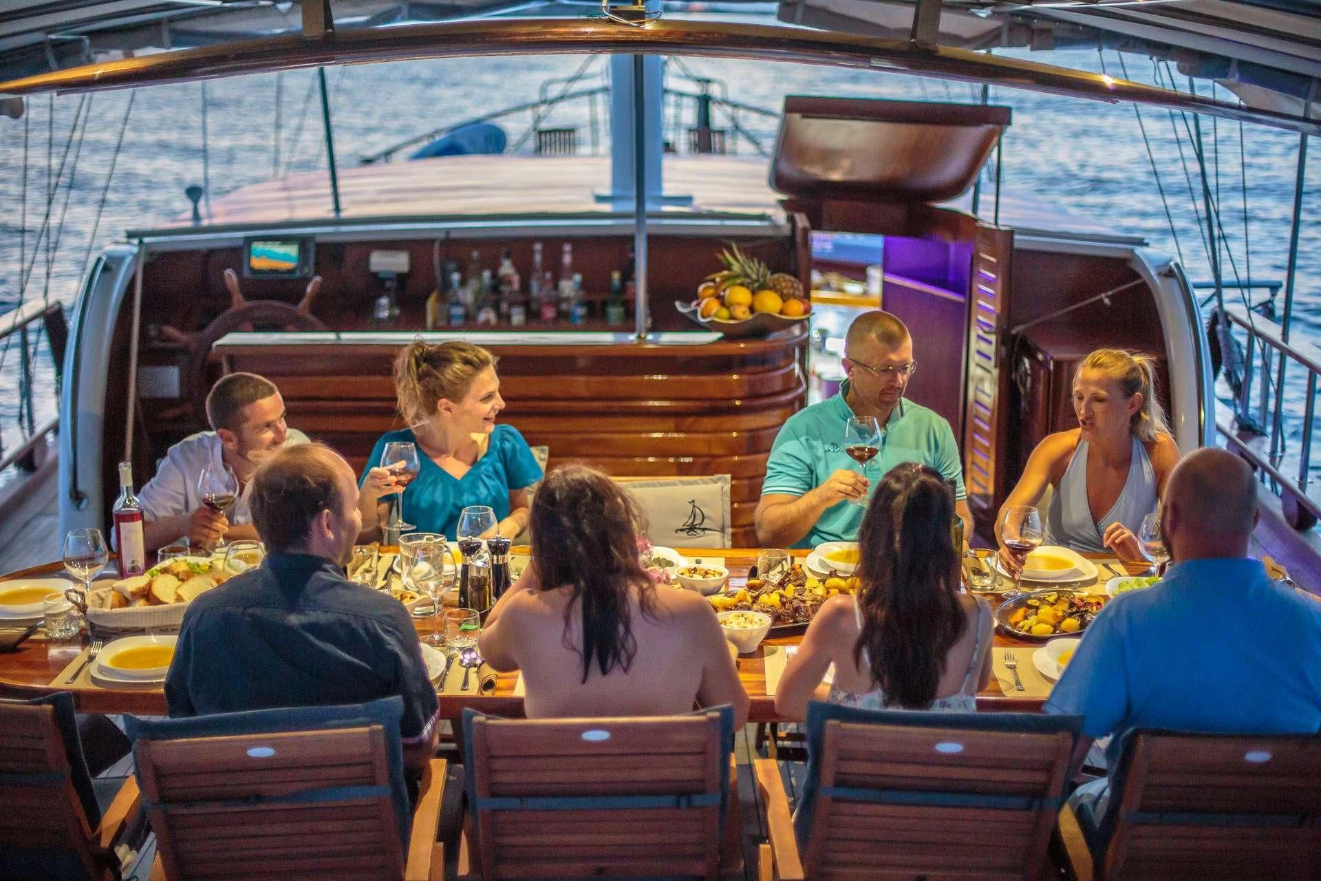 a group of people eating at a restaurant aboard ALLURE E Yacht for Sale