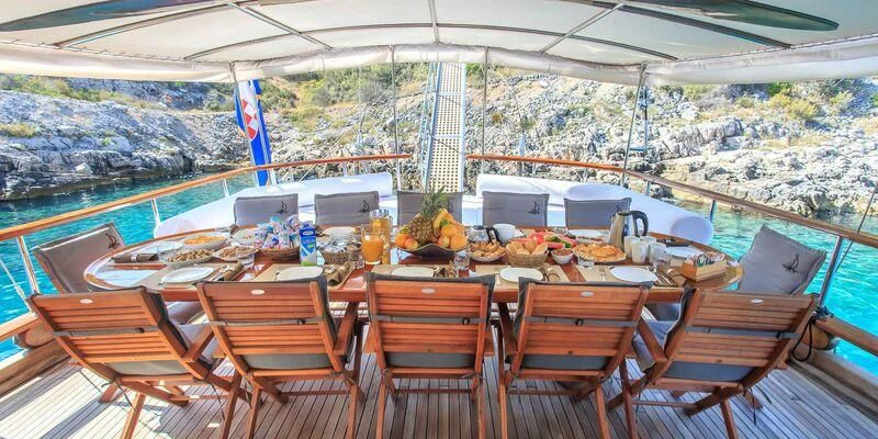 a table set for a meal aboard ALLURE E Yacht for Sale
