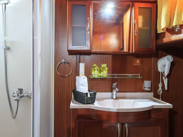 a bathroom with a sink and a mirror aboard ALLURE E Yacht for Sale