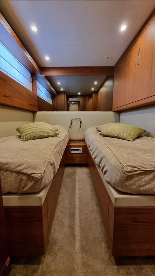 a room with two beds aboard BRIVIDO Yacht for Sale