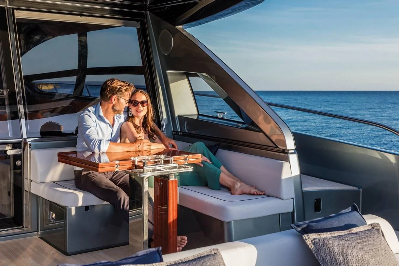 a man and woman sitting in a car aboard RIVA 66' RIBELLE Yacht for Sale