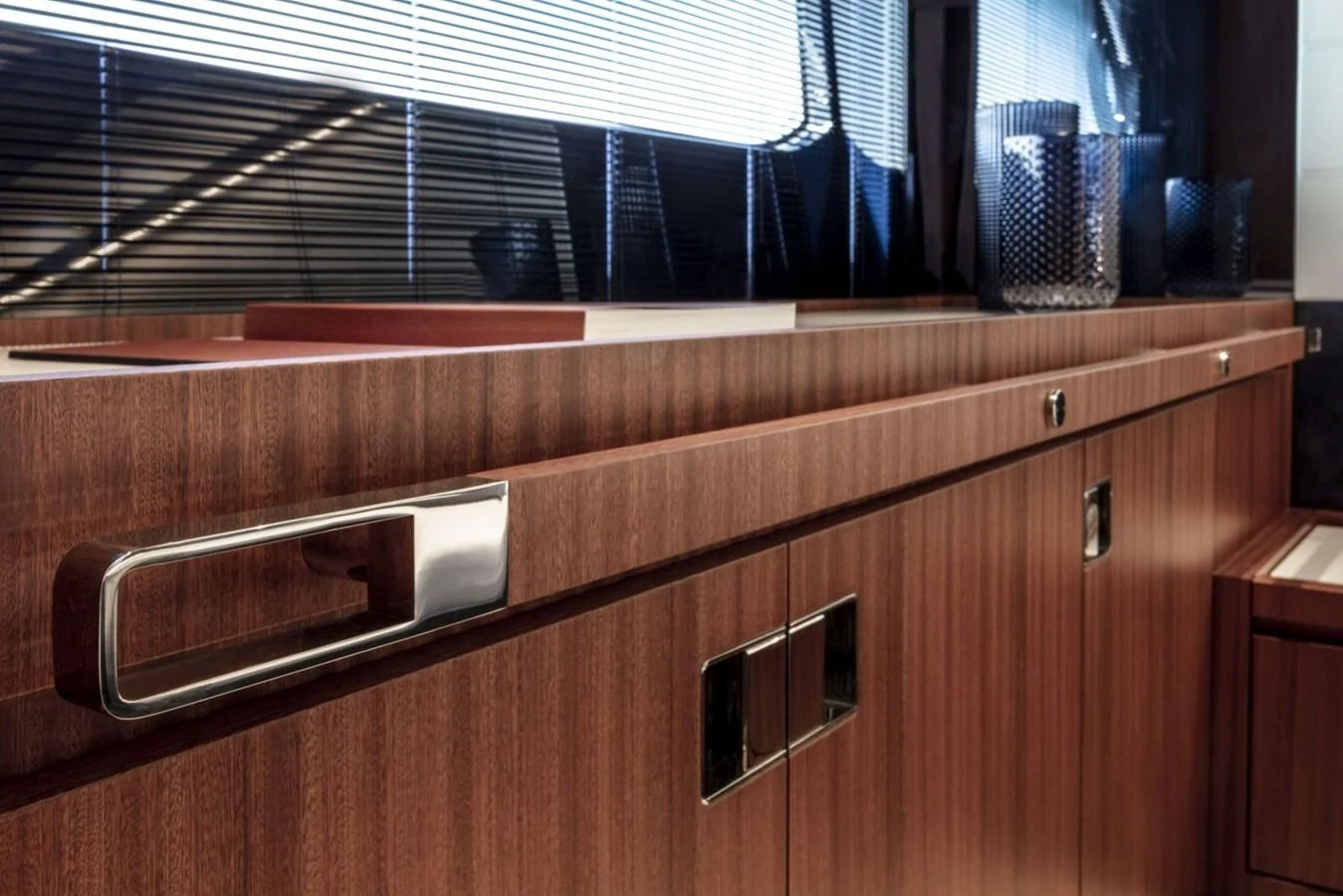 a wooden cabinet with a silver knob aboard RIVA 66' RIBELLE Yacht for Sale