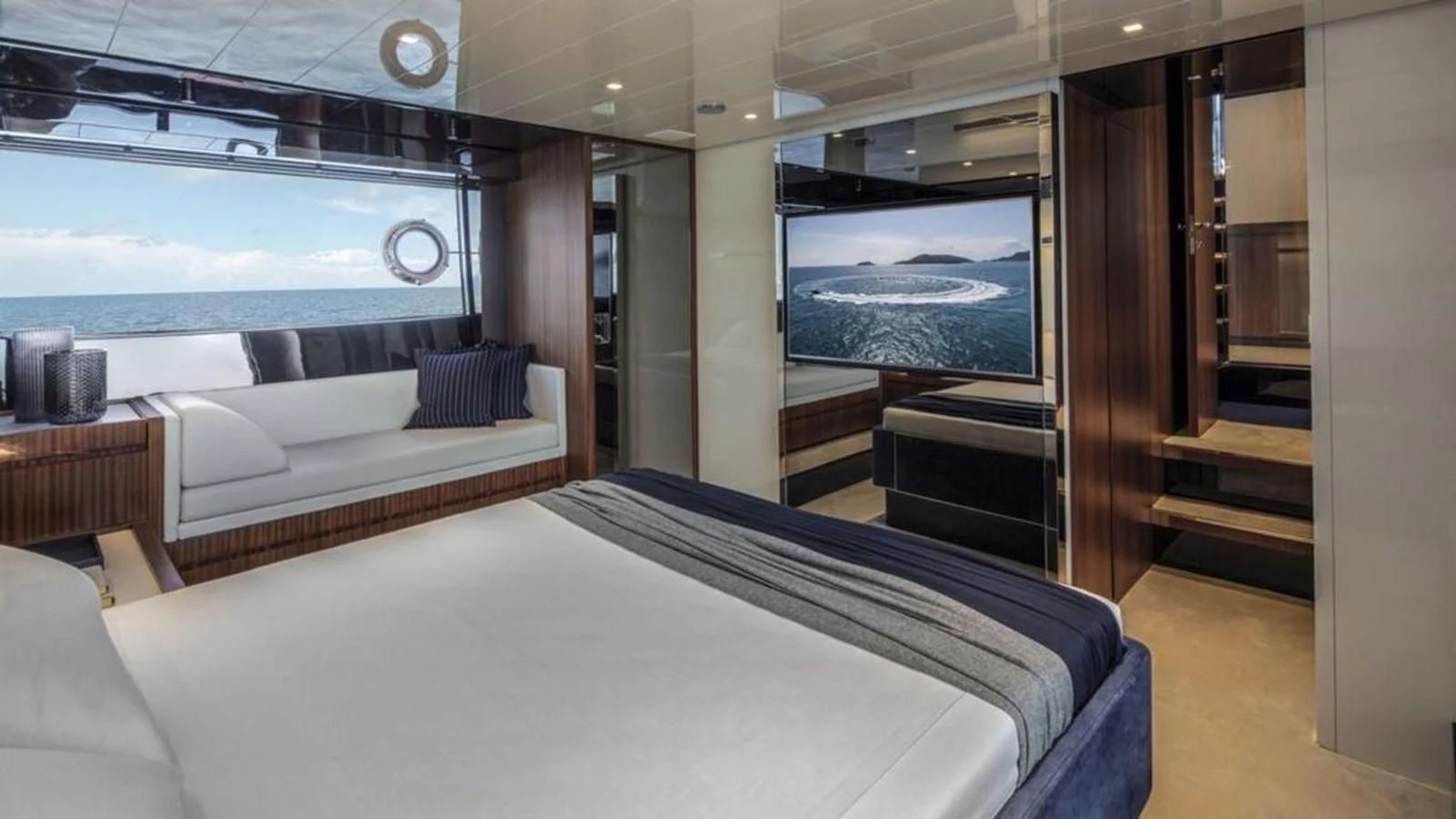 a room with a bed and a large window aboard RIVA 66' RIBELLE Yacht for Sale