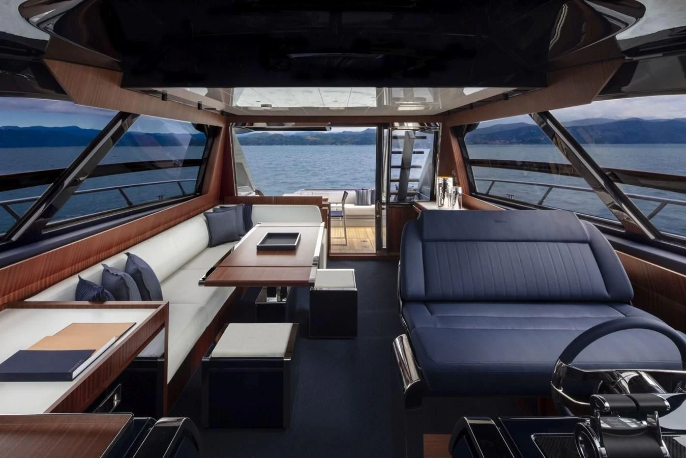 a boat with a table and chairs aboard RIVA 66' RIBELLE Yacht for Sale