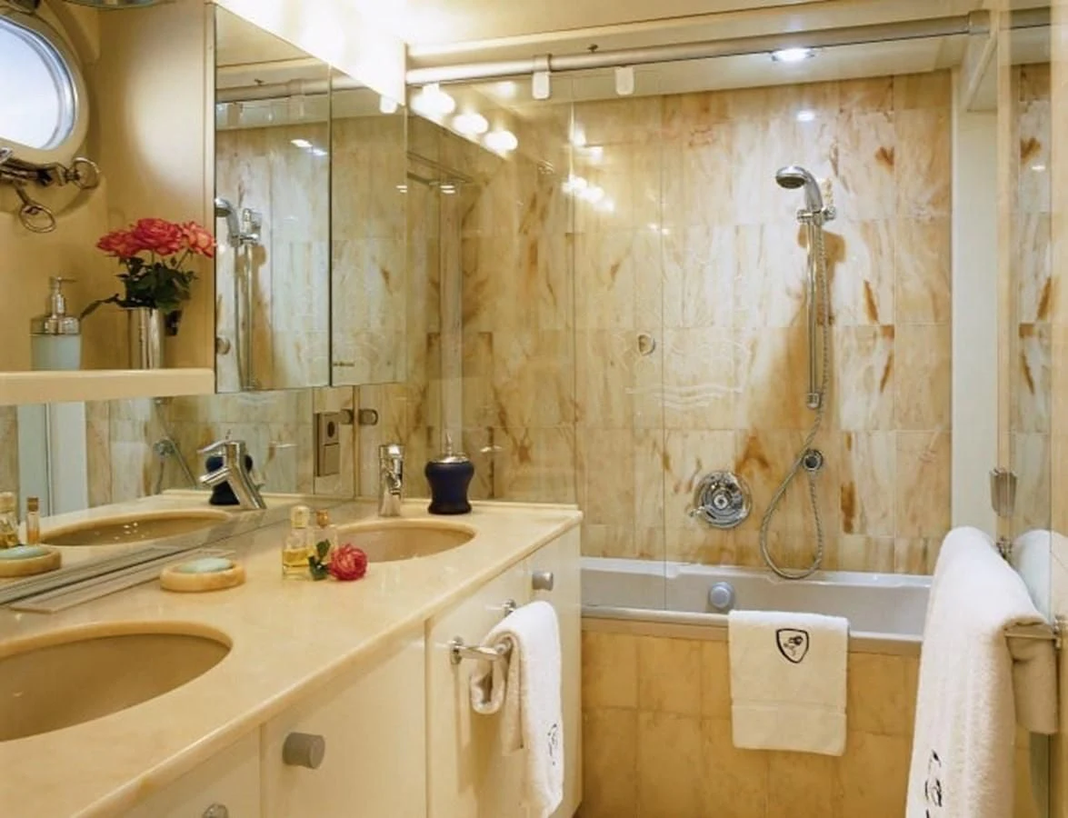 a bathroom with a shower curtain and sink aboard COSTA MAGNA Yacht for Sale