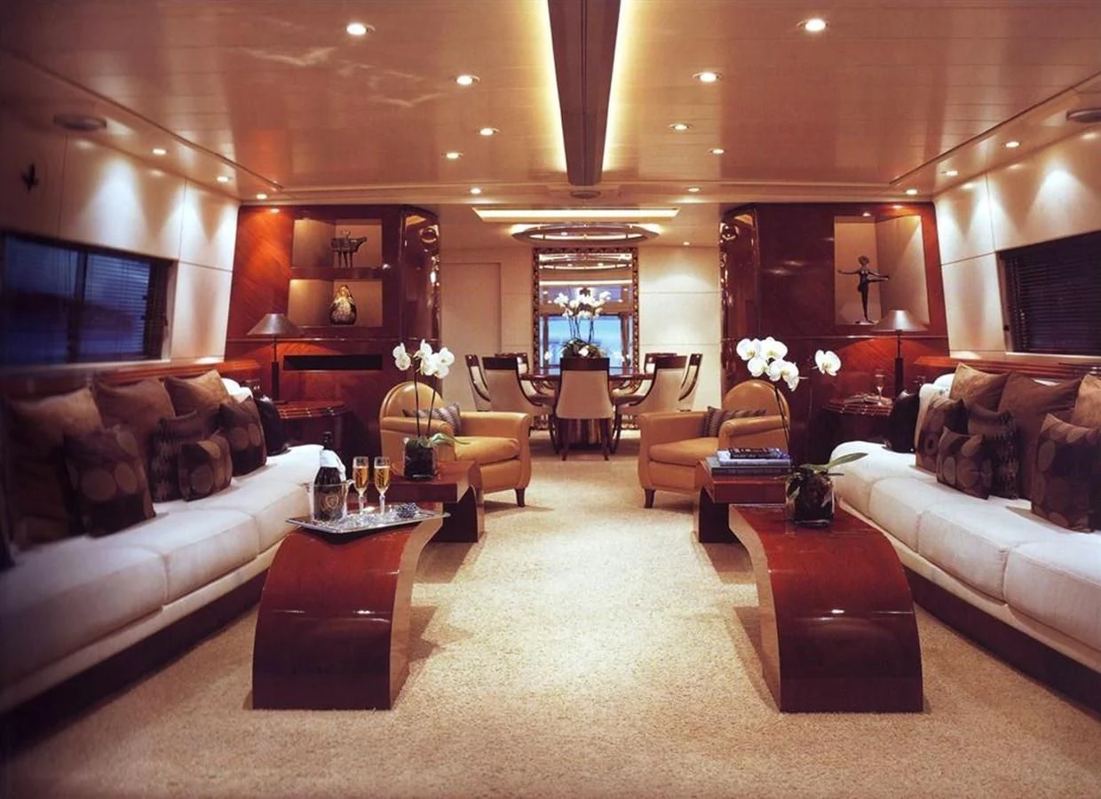 a living room with a large white couch and a large window aboard COSTA MAGNA Yacht for Sale