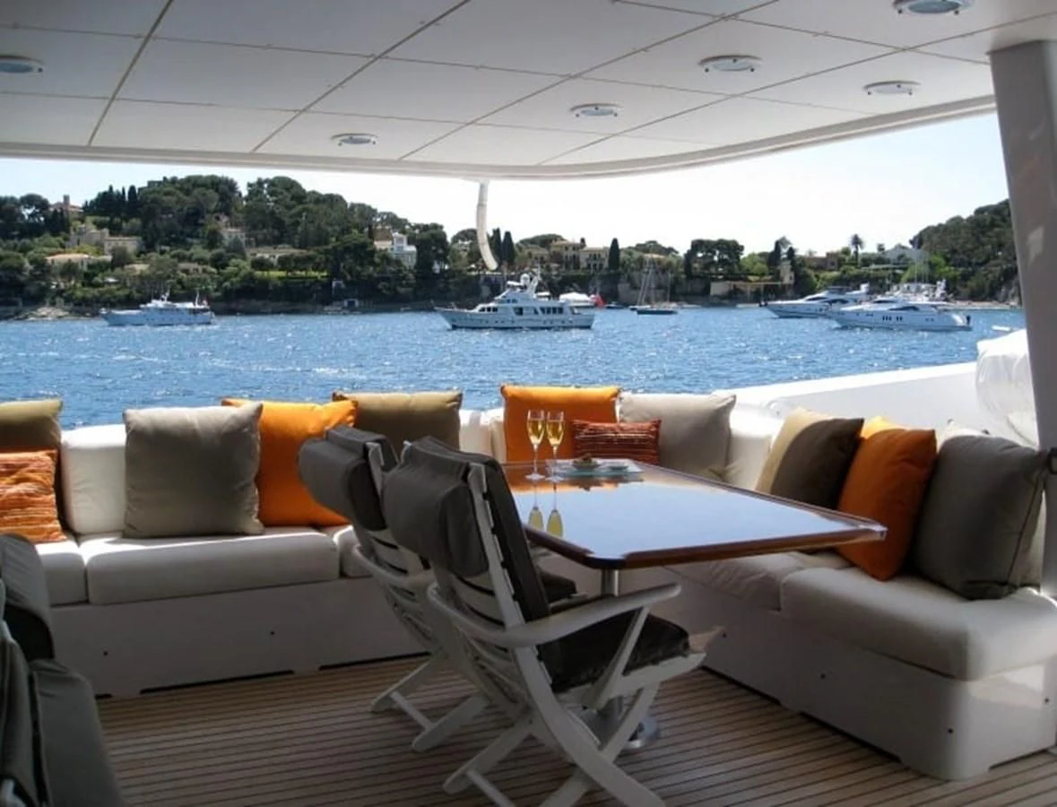 a room with couches and chairs aboard COSTA MAGNA Yacht for Sale