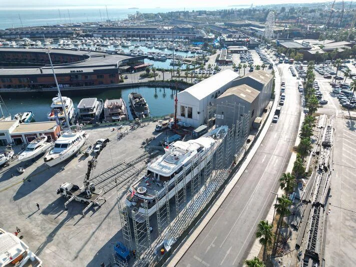 a large building with a dock and boats in the water aboard COSTA MAGNA Yacht for Sale