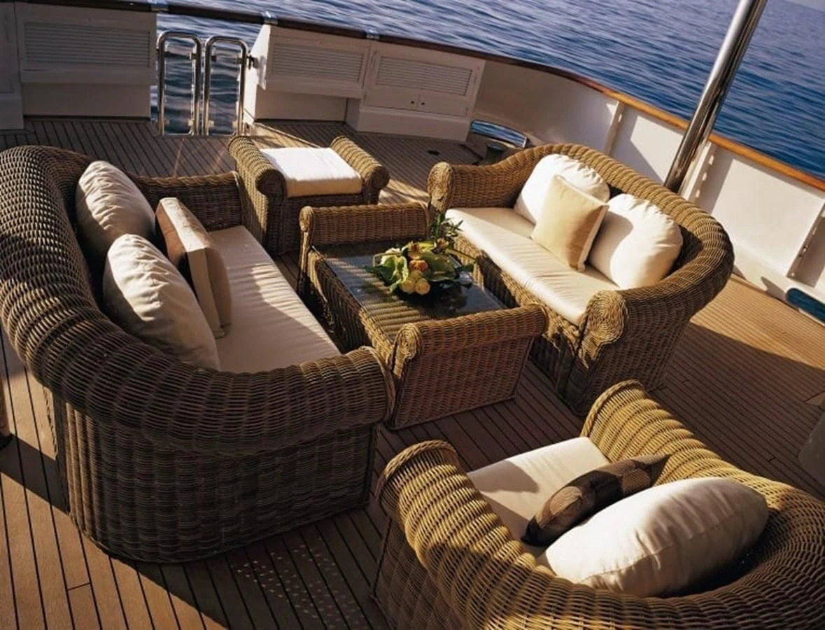 a living room with couches and chairs aboard COSTA MAGNA Yacht for Sale