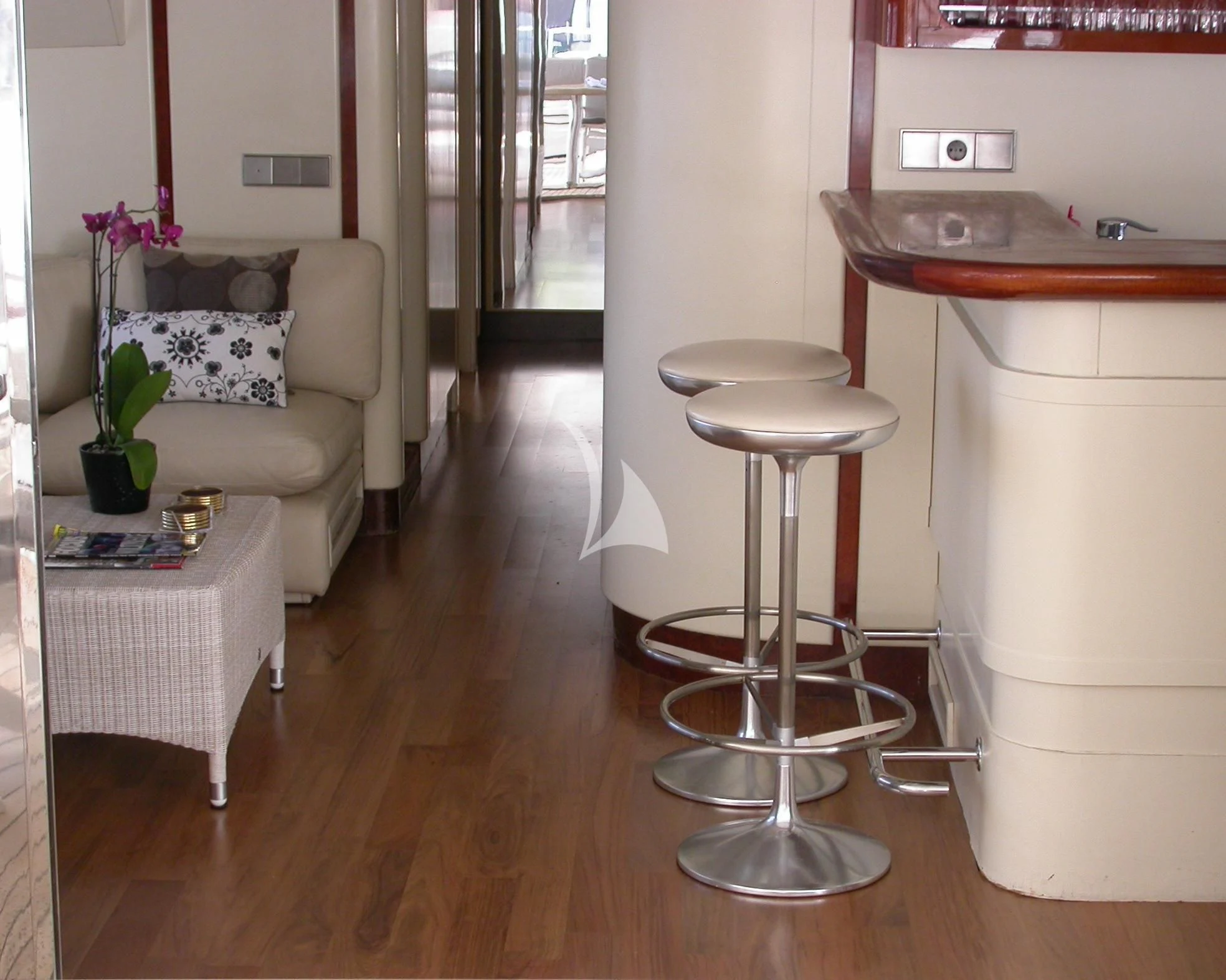 a room with a table and stools aboard COSTA MAGNA Yacht for Sale