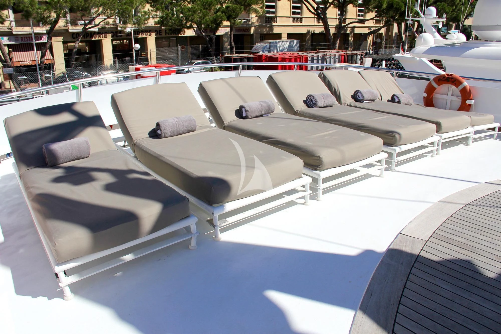 a group of white lounge chairs aboard COSTA MAGNA Yacht for Sale