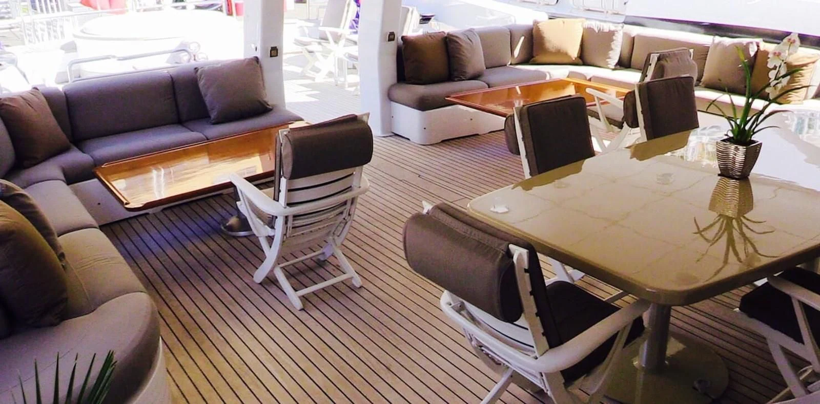 a living room with a table and chairs aboard COSTA MAGNA Yacht for Sale