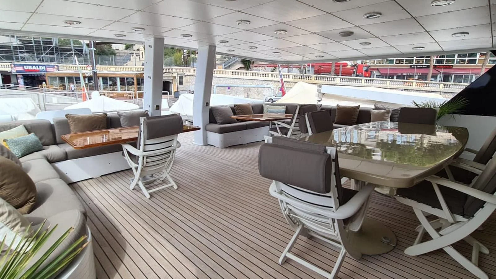 a room with a table chairs and a couch aboard COSTA MAGNA Yacht for Sale