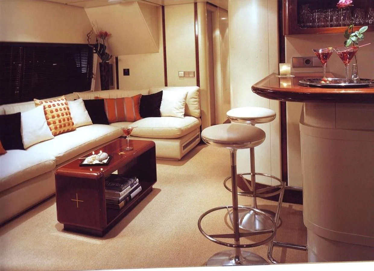 a living room with a couch and coffee table aboard COSTA MAGNA Yacht for Sale