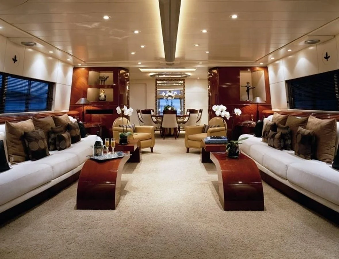 a living room with a white couch and a large mirror aboard COSTA MAGNA Yacht for Sale