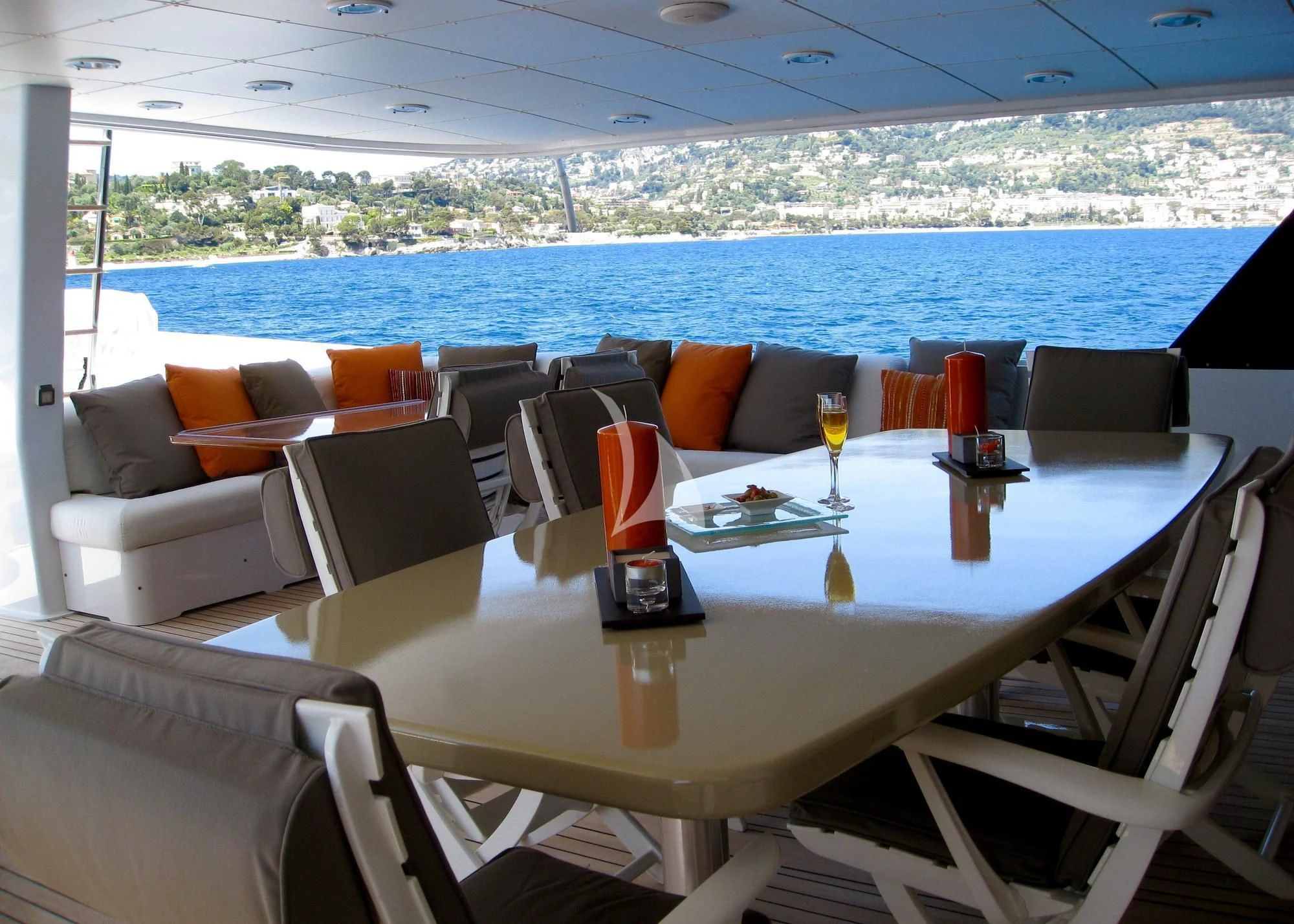 a table with chairs and a view of the ocean aboard COSTA MAGNA Yacht for Sale