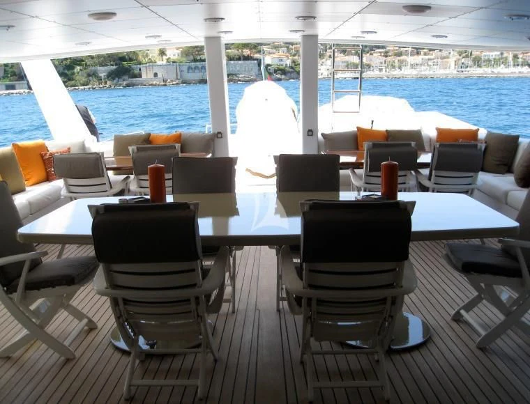 a room with chairs and tables aboard COSTA MAGNA Yacht for Sale