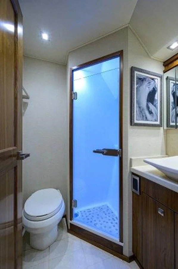 a bathroom with a blue door aboard PASTIME Yacht for Sale