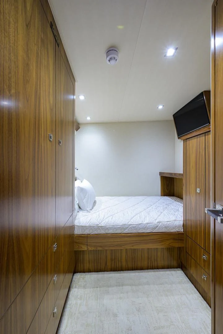 a bedroom with a wood door aboard PASTIME Yacht for Sale