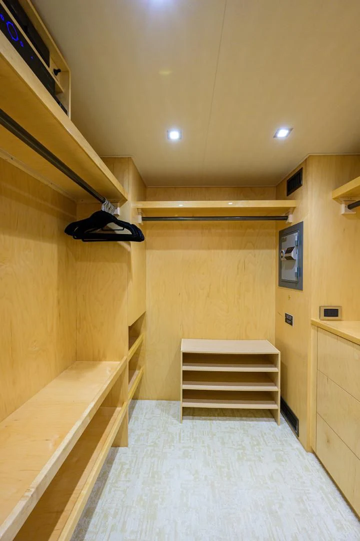 a hallway with a wood door and a carpet aboard PASTIME Yacht for Sale