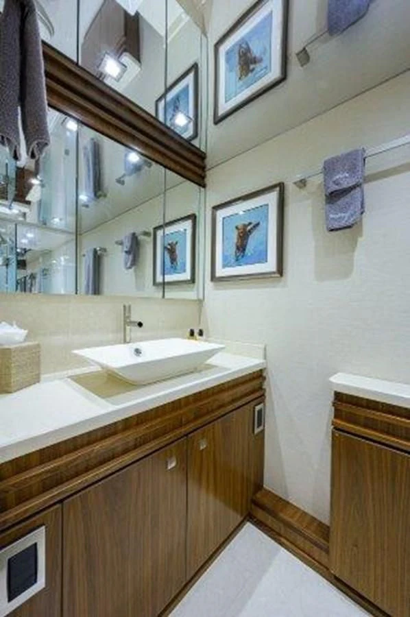 a bathroom with a sink and a mirror aboard PASTIME Yacht for Sale