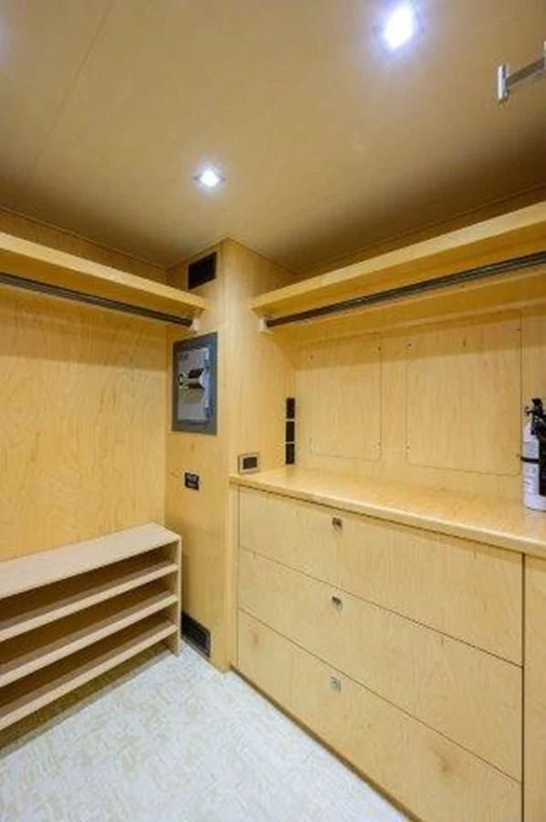 a room with wooden cabinets aboard PASTIME Yacht for Sale