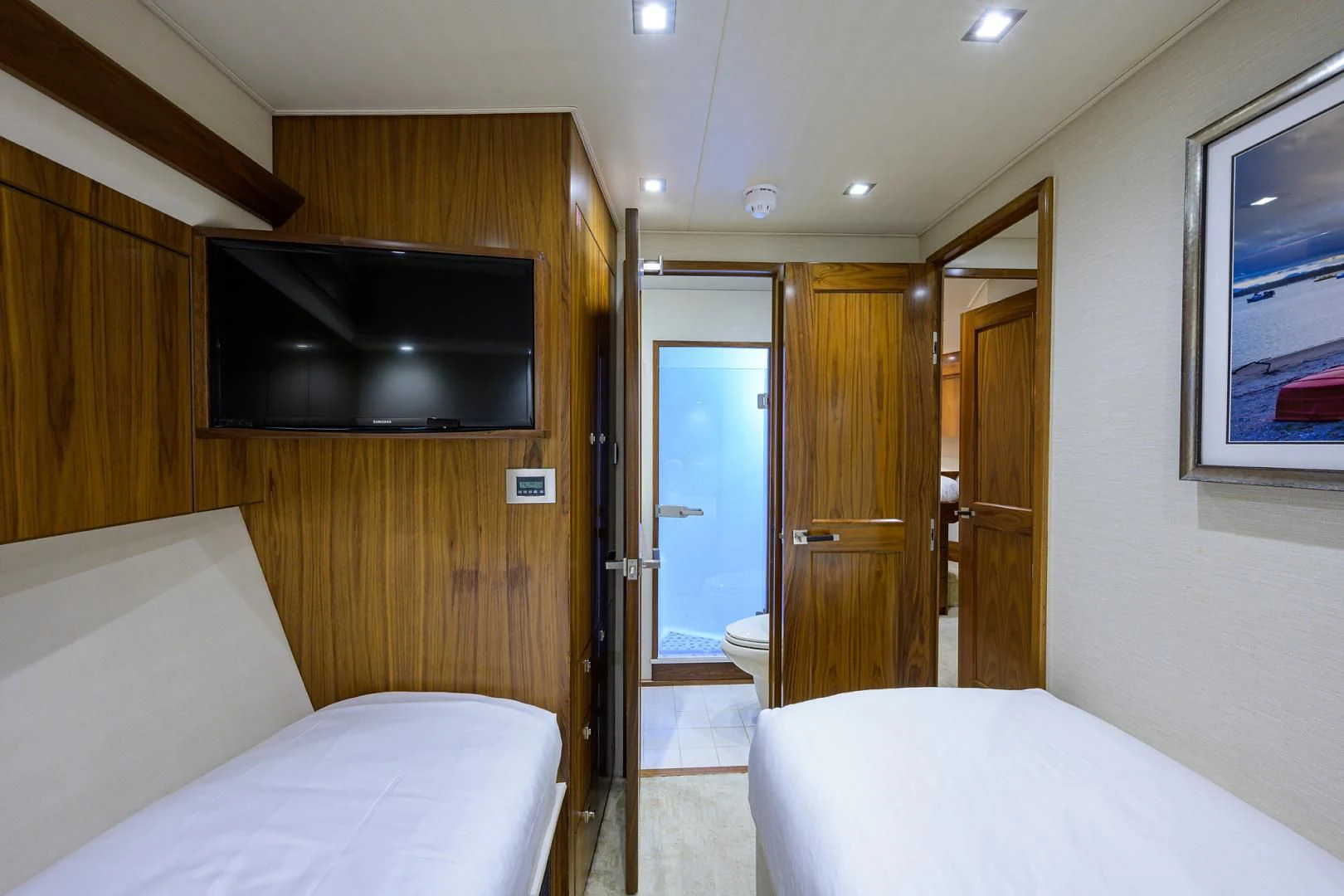 a room with a bed and a television aboard PASTIME Yacht for Sale